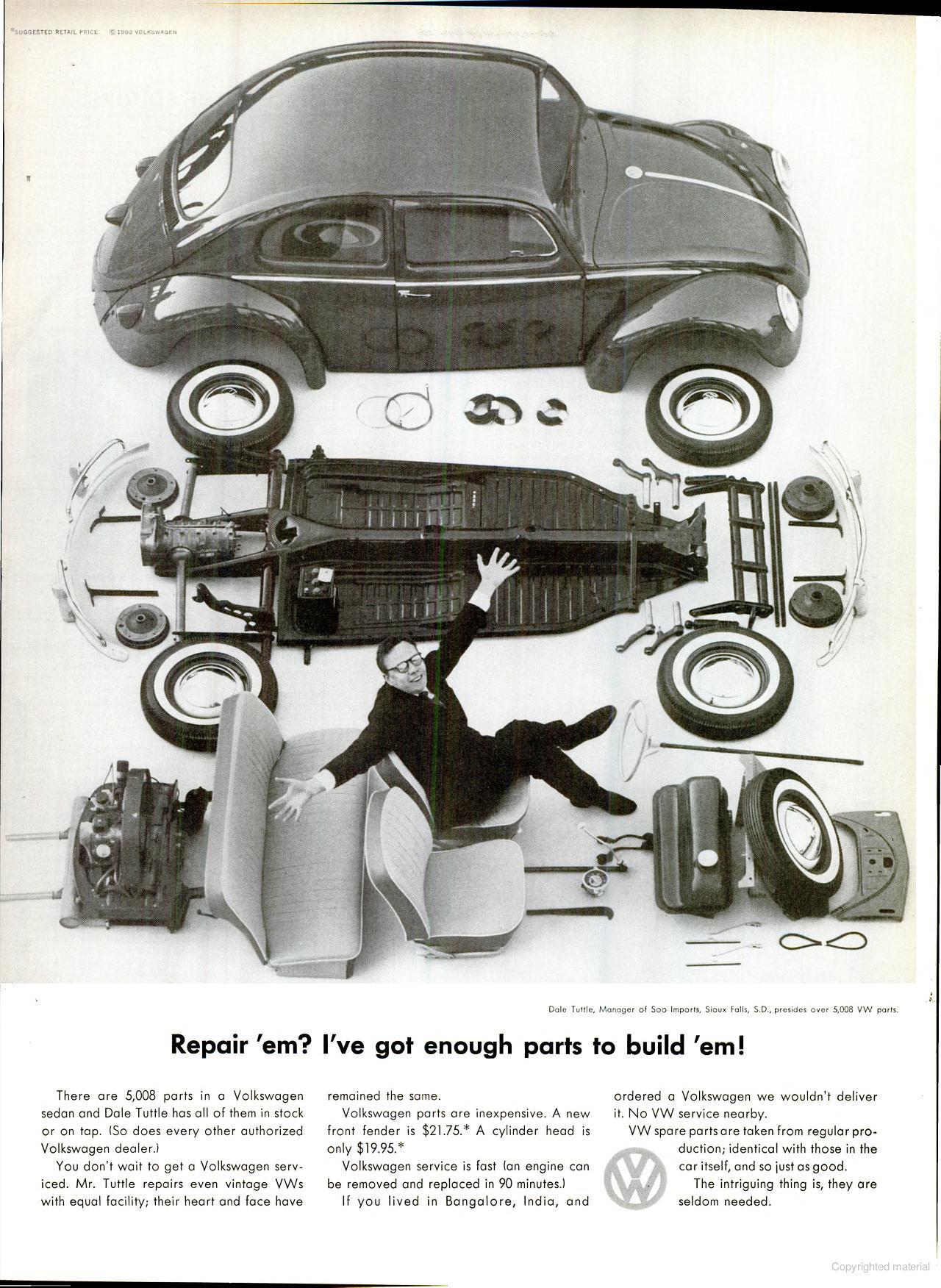 A VW bug taken apart completely with all of the parts laid out.